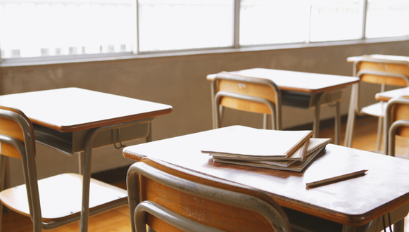 放課後の学校に並ぶ机
